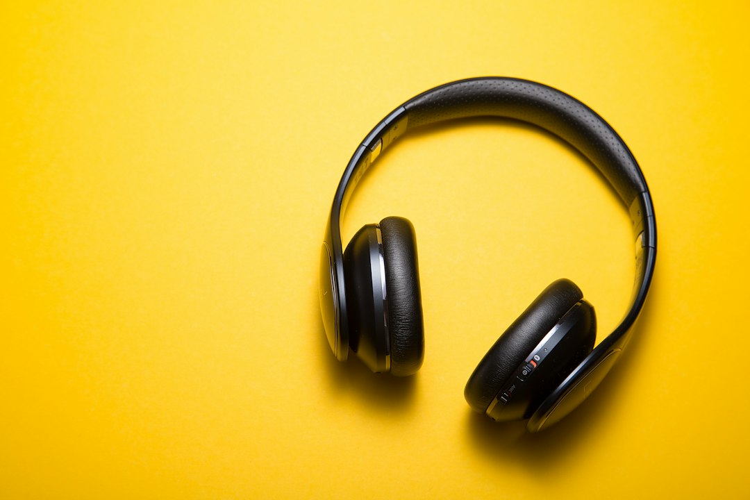 Wireless headphones photographed on a yellow background