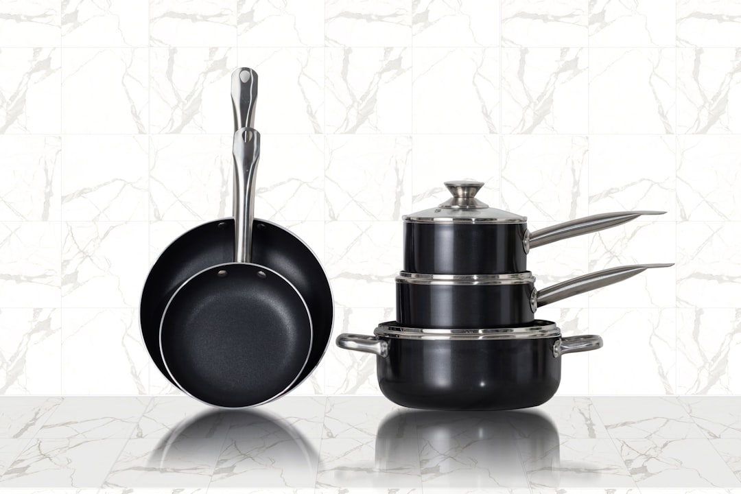 Stainless steel cooking pots arranged on a surface